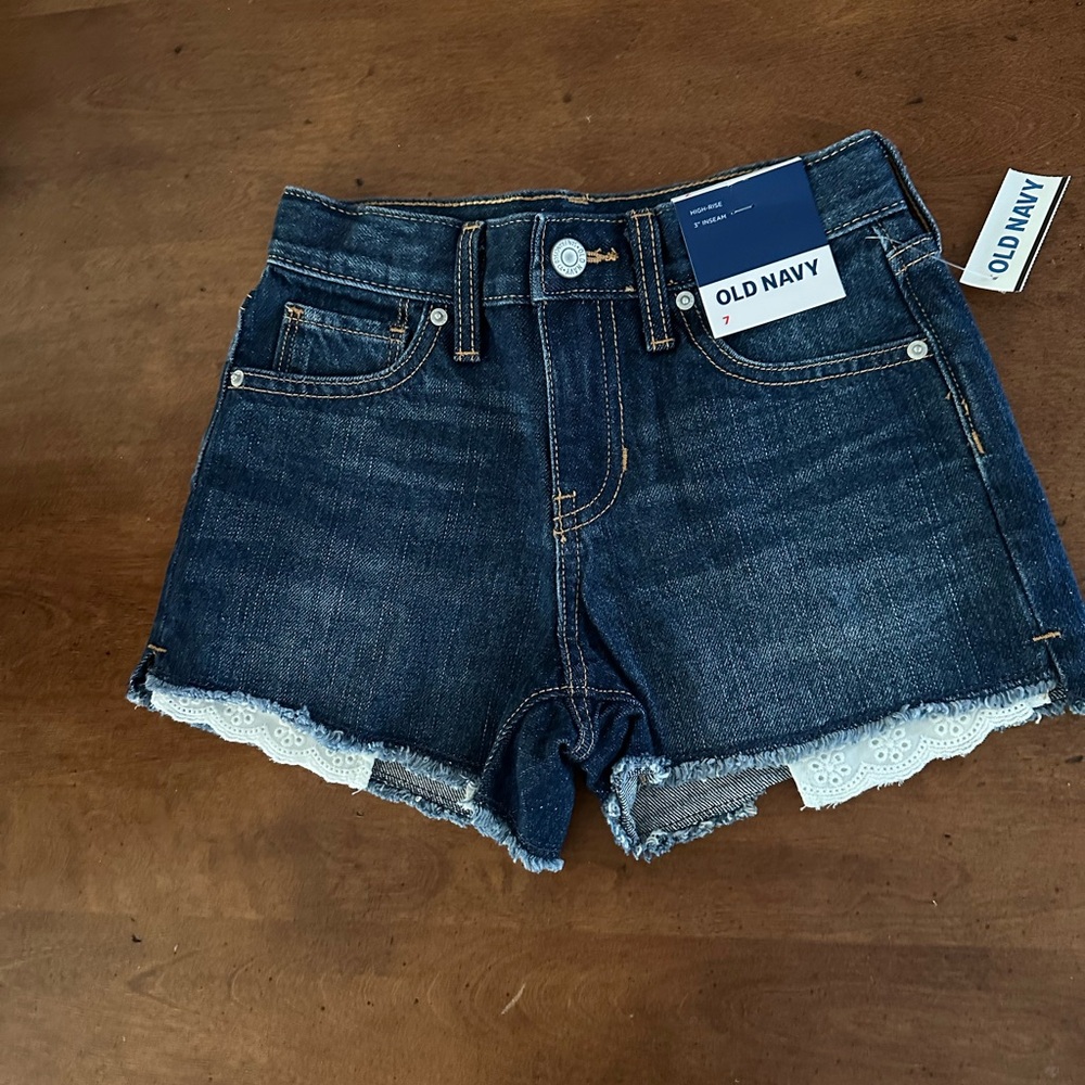 Old Navy blue jean shorts eyelet sewn in front pockets with frayed hem